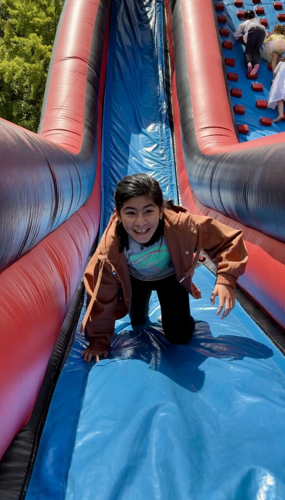Zoe at the Bouncy House Slide at the Great Big Family Play Day Event